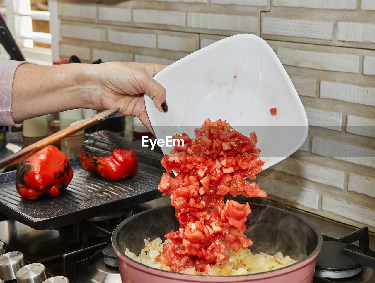 cropped hand of person preparing food in kitchen