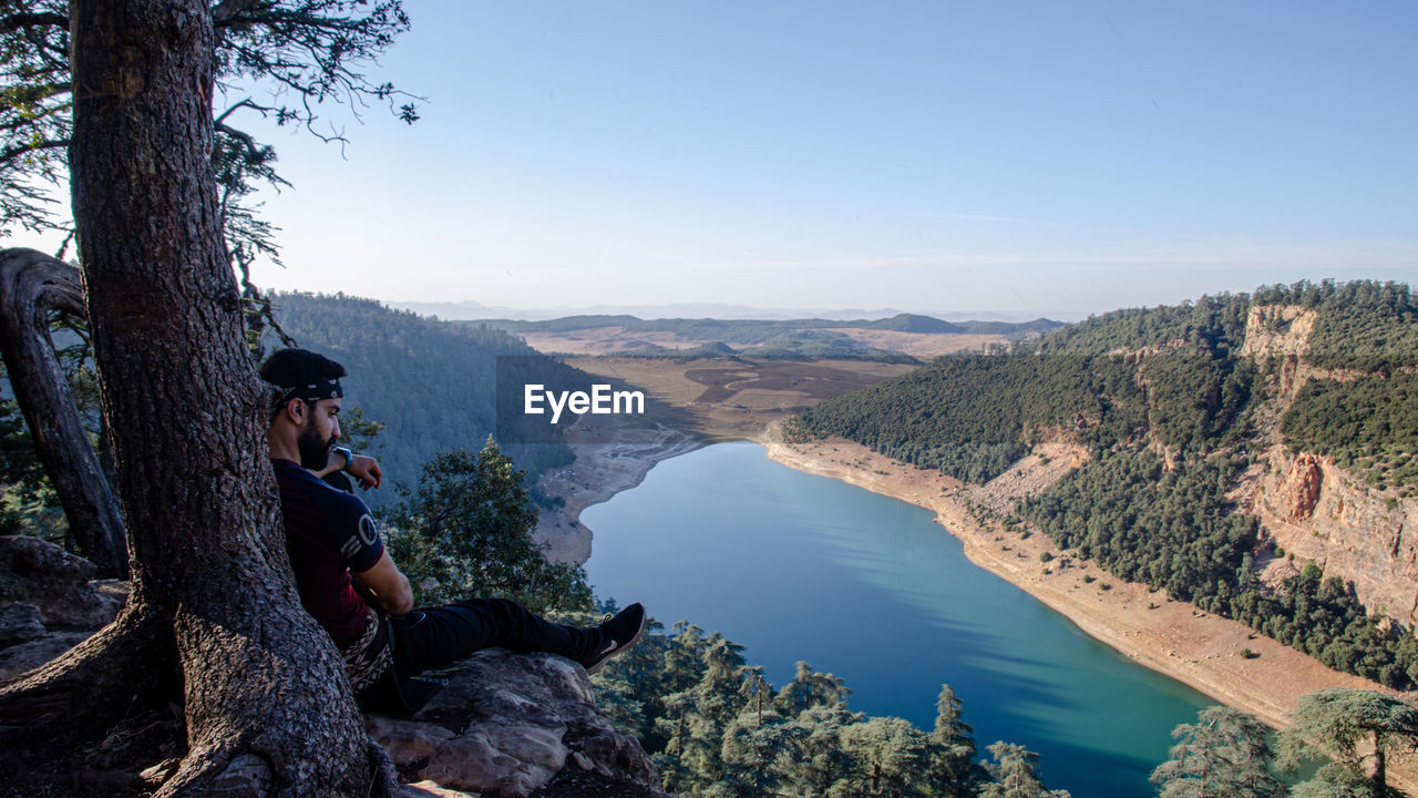 Hiking man looking at aguelmam azigza 