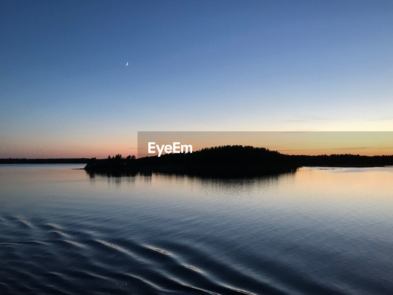 SCENIC VIEW OF LAKE AGAINST ORANGE SKY