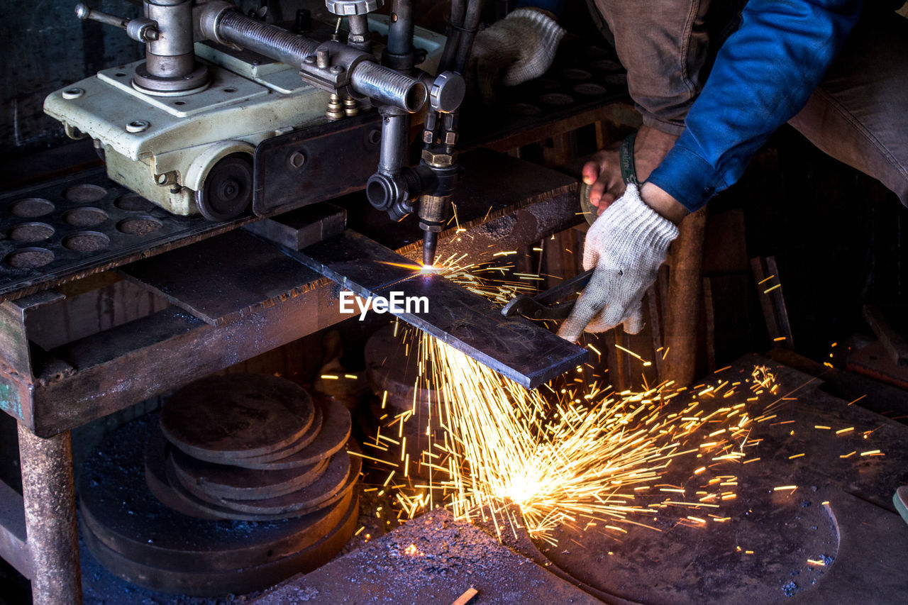 Midsection of man working at workshop