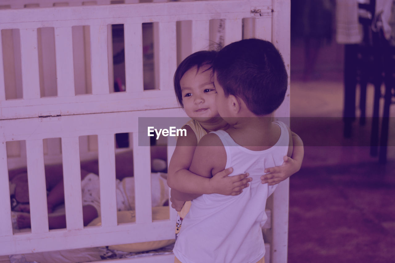 Boy with sister at home