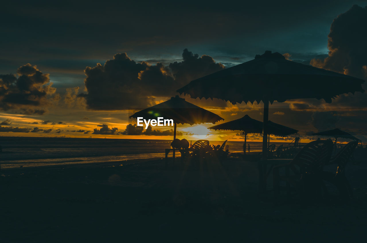 Scenic view of beach against sky during sunset