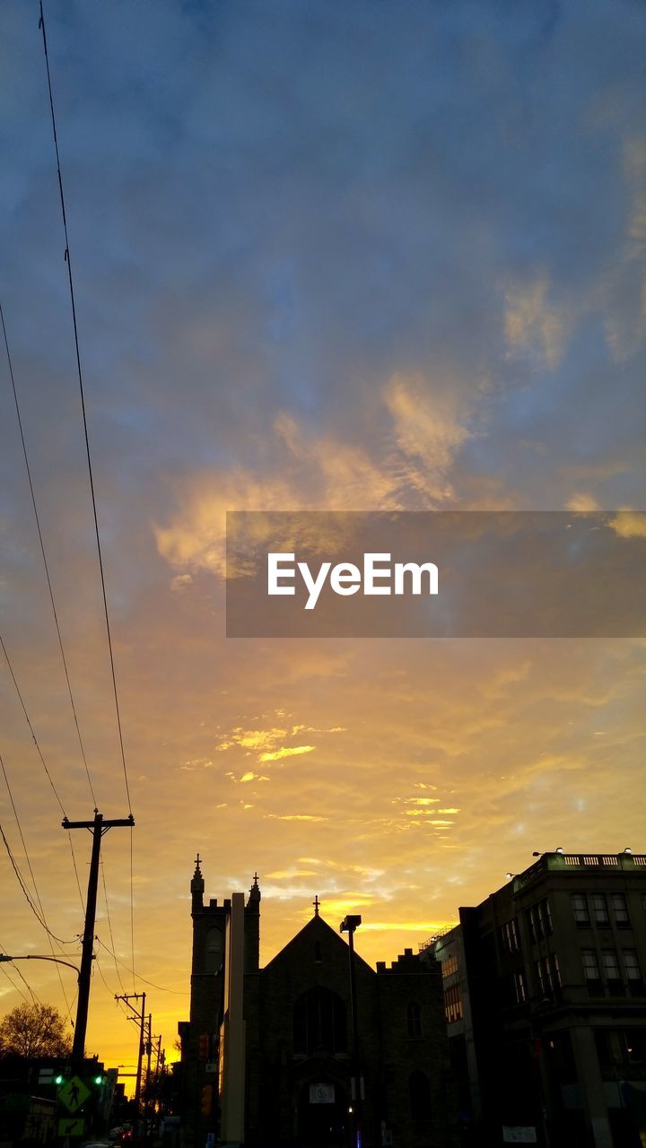 LOW ANGLE VIEW OF BUILDINGS AT SUNSET