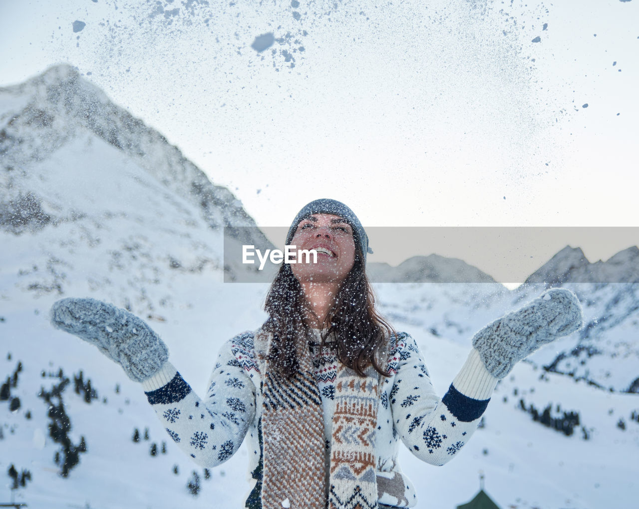 Winter portrait of a young woman, snow, mountain, outdoors, happy