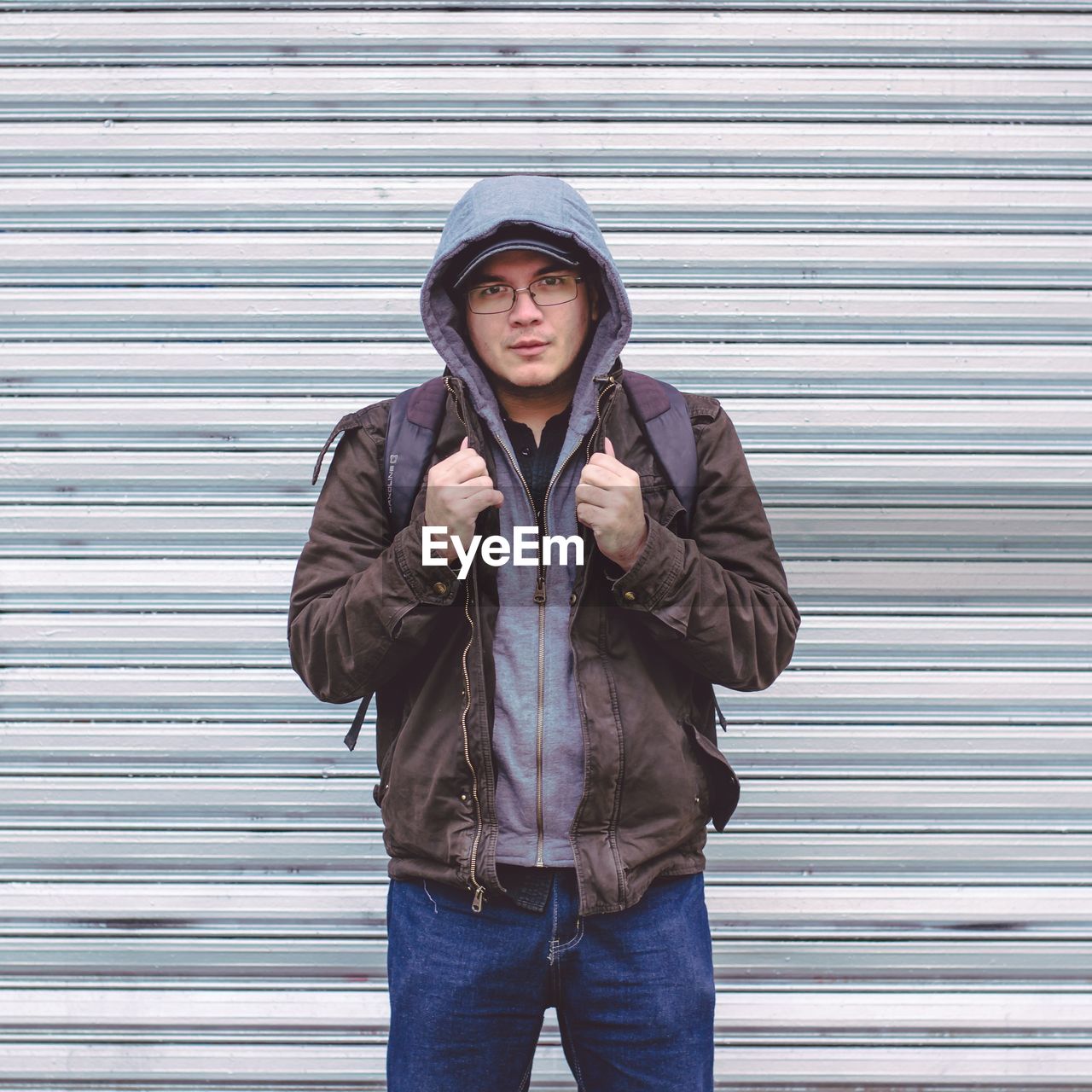 Full length of man in hooded shirt standing outdoors