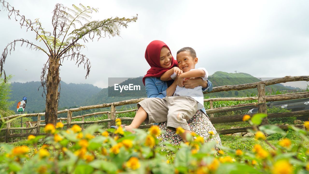 togetherness, two people, child, adult, flower, emotion, childhood, family, baby, positive emotion, men, happiness, nature, women, bonding, parent, plant, female, one parent, love, leisure activity, smiling, sky, lifestyles, toddler, enjoyment, casual clothing, day, full length, landscape, grass, fun, beauty in nature, outdoors, cheerful, rural scene, joy, holiday, father, trip, person, flowering plant, vacation, care, young adult