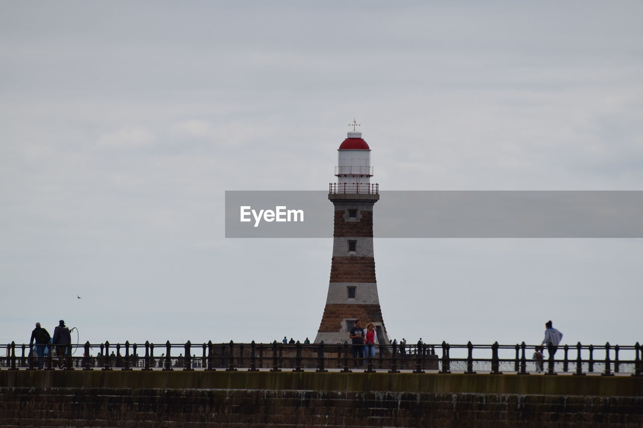 VIEW OF LIGHTHOUSE AGAINST BUILDINGS