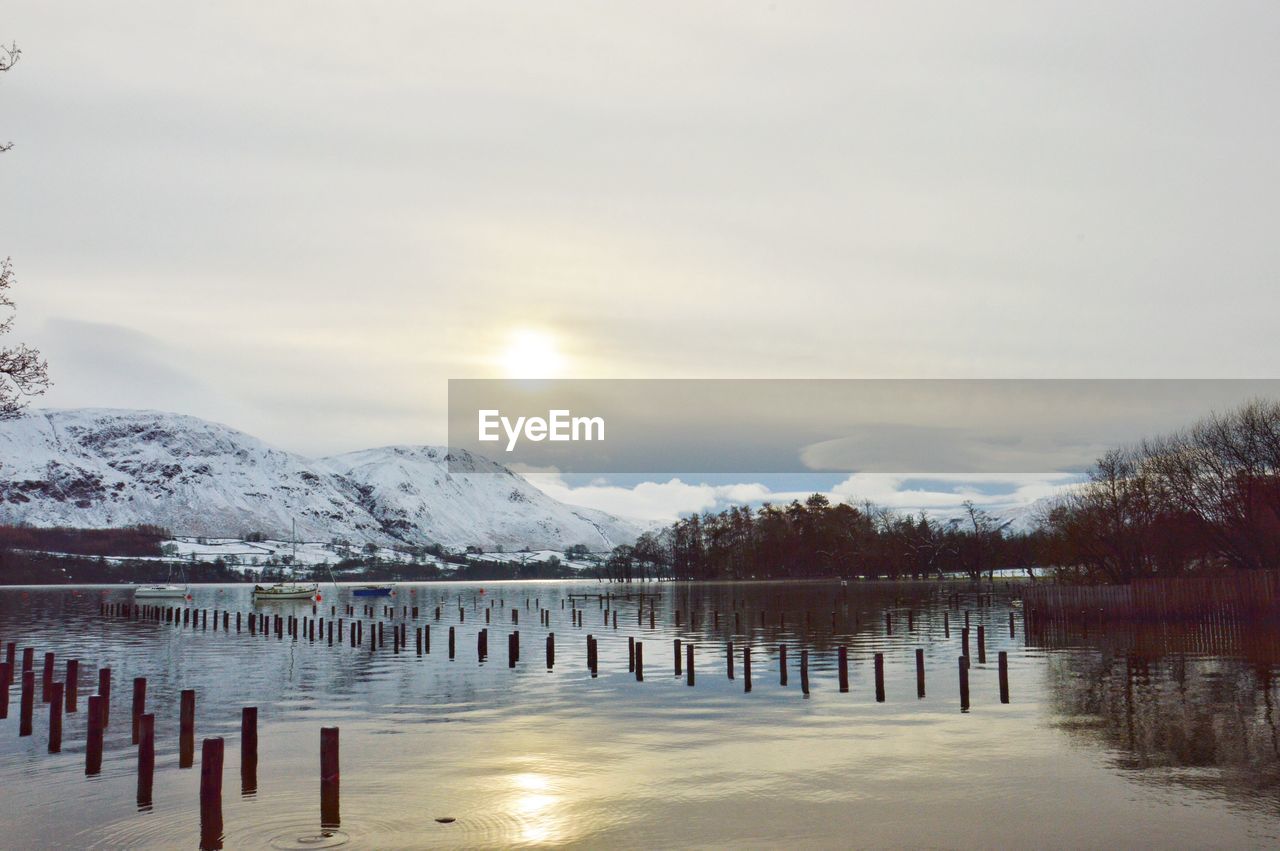 Scenic view of lake against cloudy sky