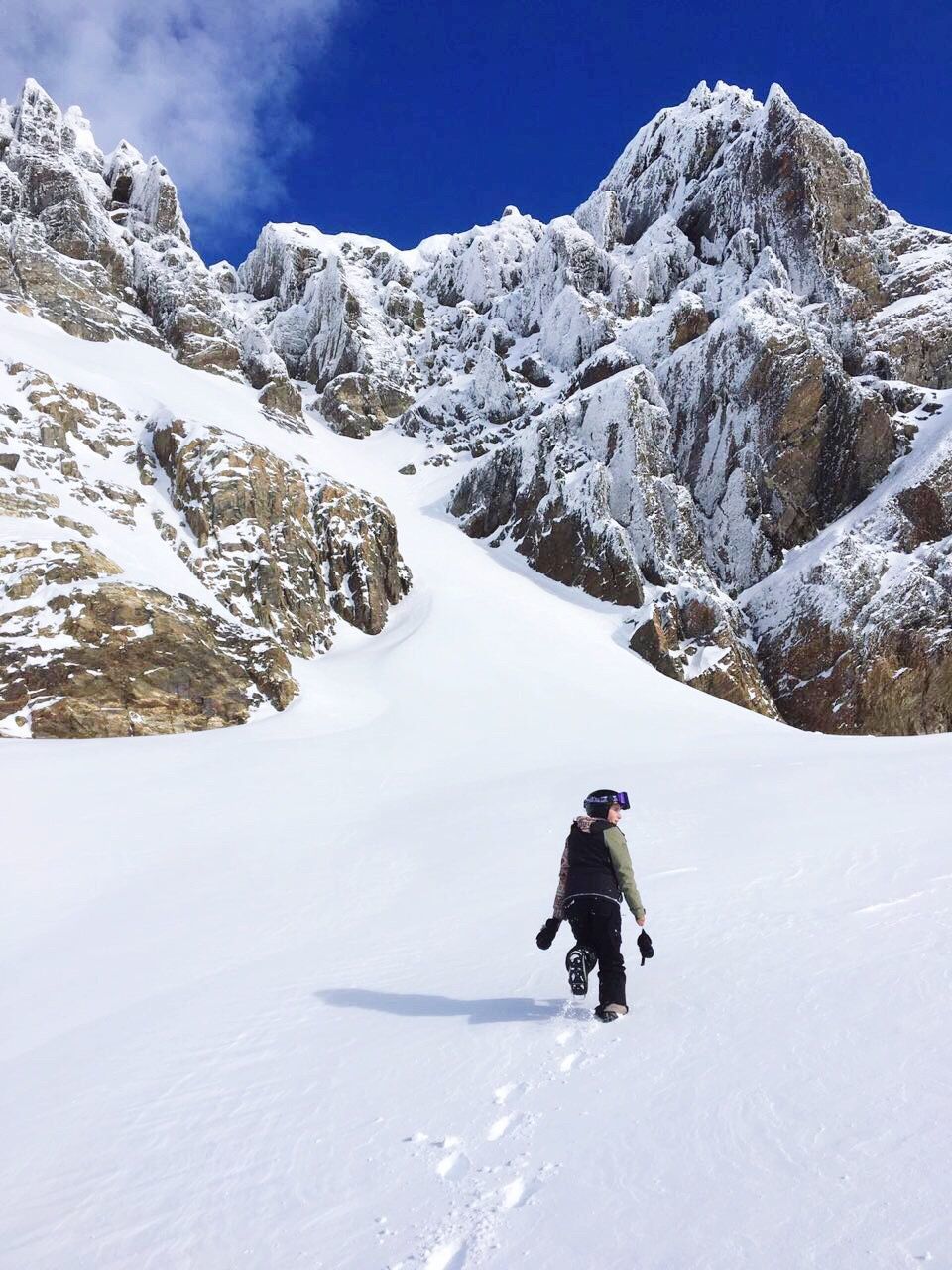 WOMAN IN SNOW COVERED MOUNTAIN