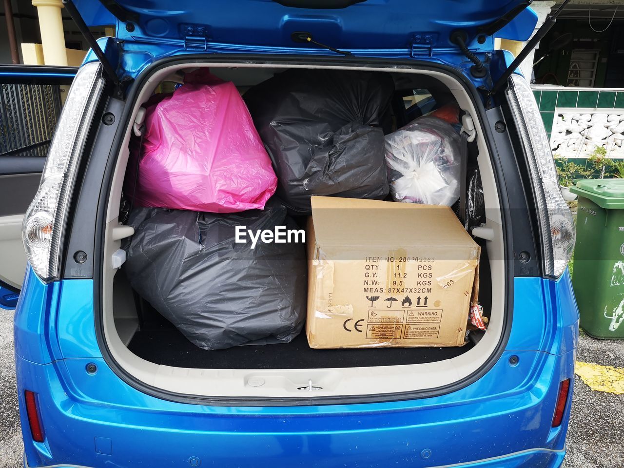 View of garbage in car trunk