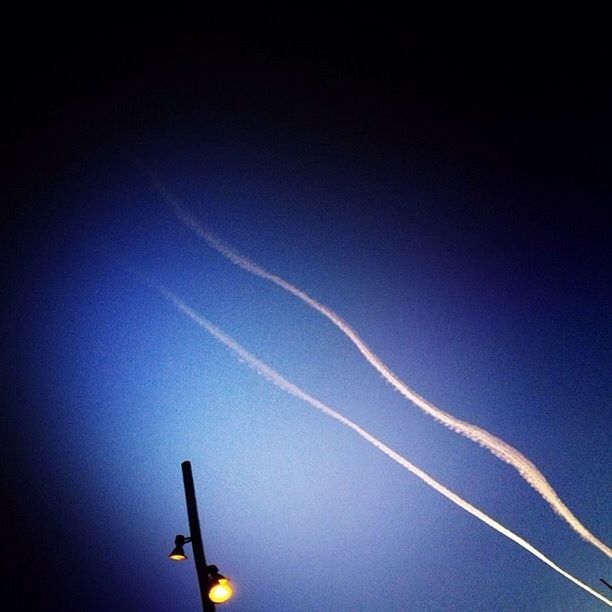 LOW ANGLE VIEW OF VAPOR TRAILS IN SKY