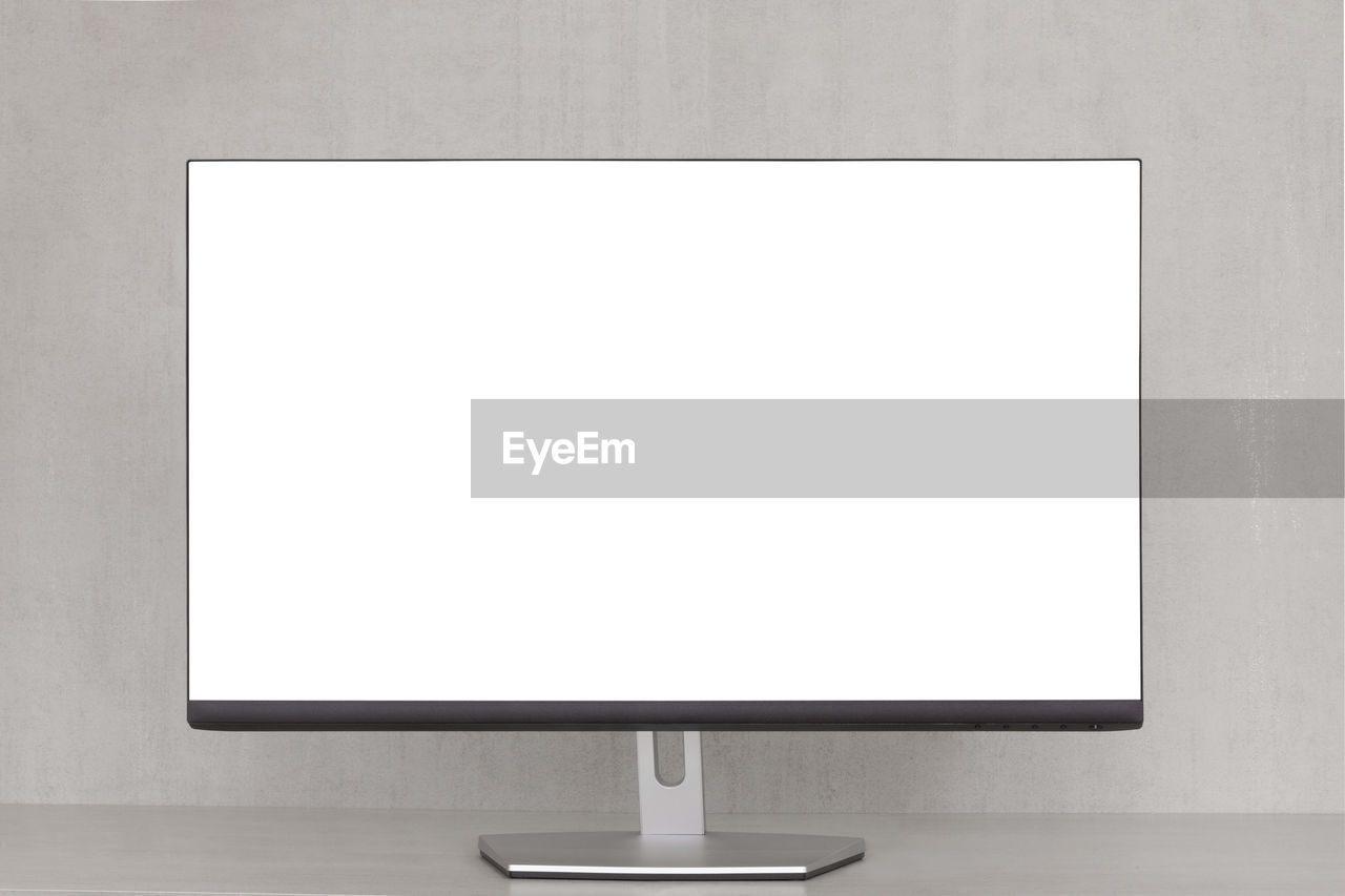 Mock up computer monitor with a white screen on a grey background