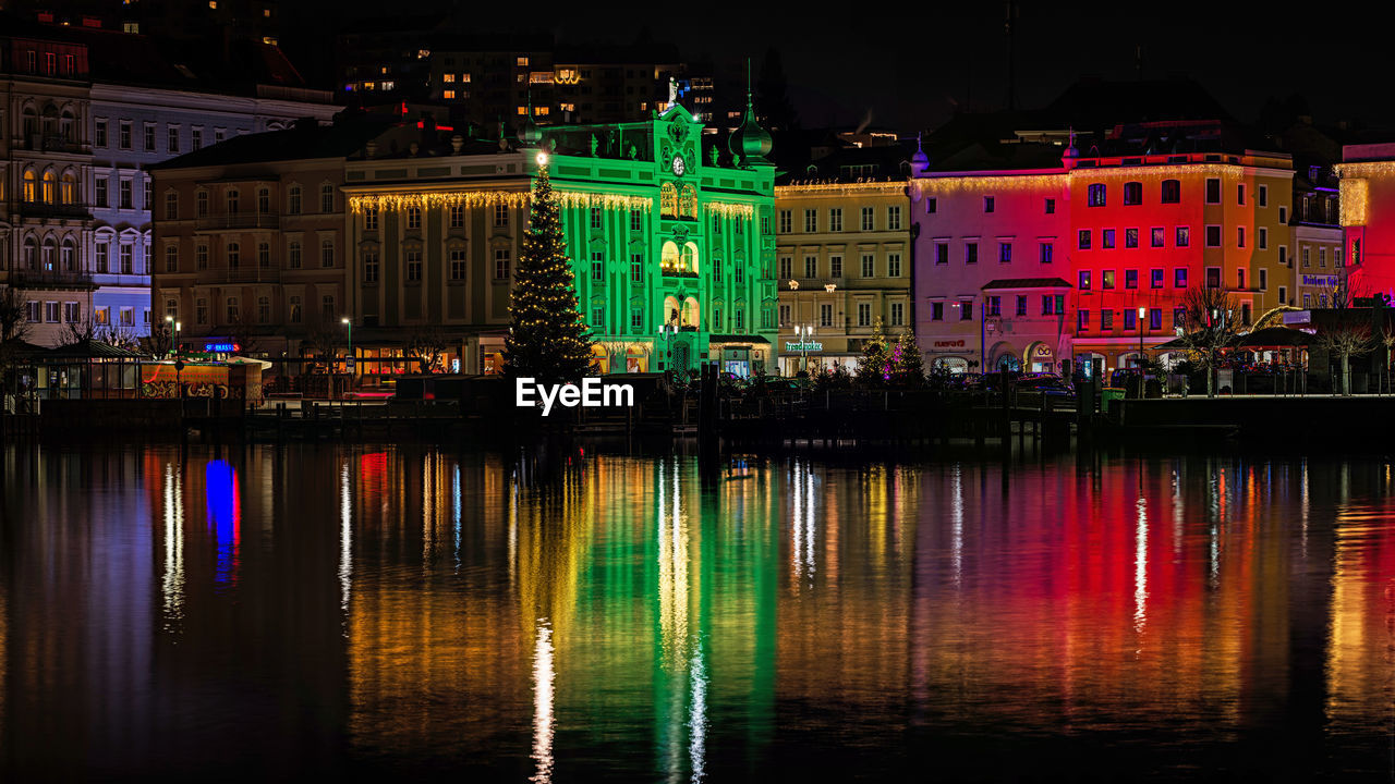 REFLECTION OF ILLUMINATED BUILDINGS IN LAKE