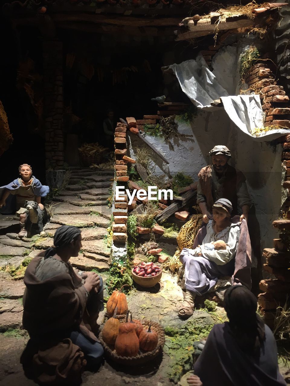 GROUP OF PEOPLE SITTING AT MARKET