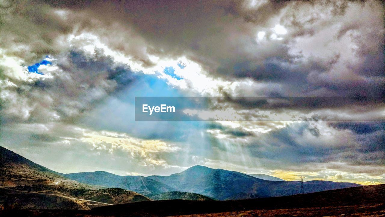 SCENIC VIEW OF CLOUDS OVER MOUNTAINS