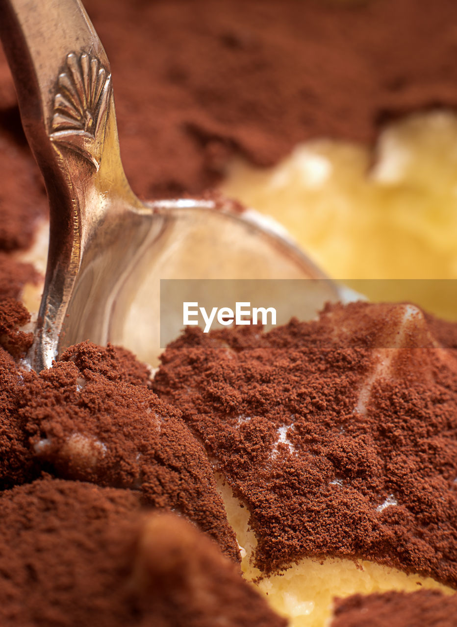 Chocolate dessert with a silver spoon. close up.