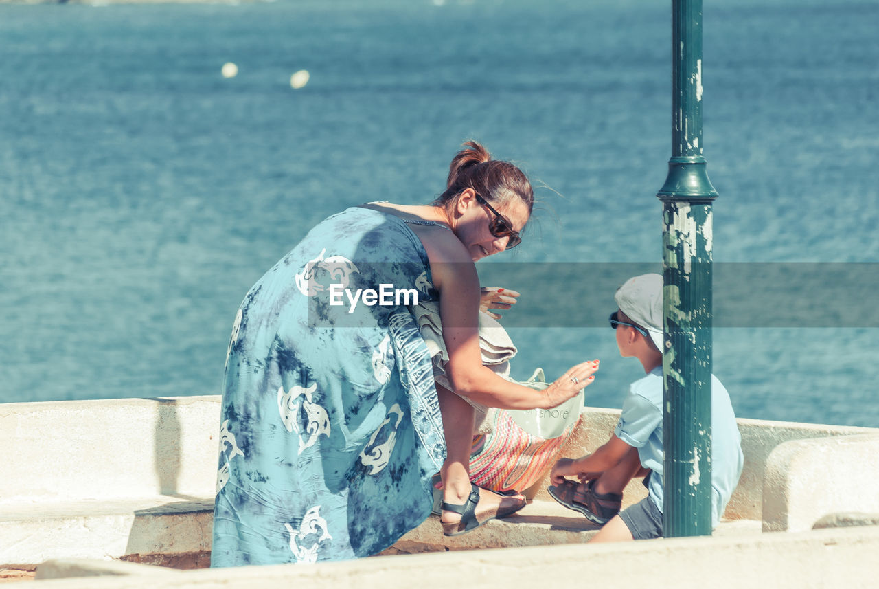 Loving mother and son at observation point by sea