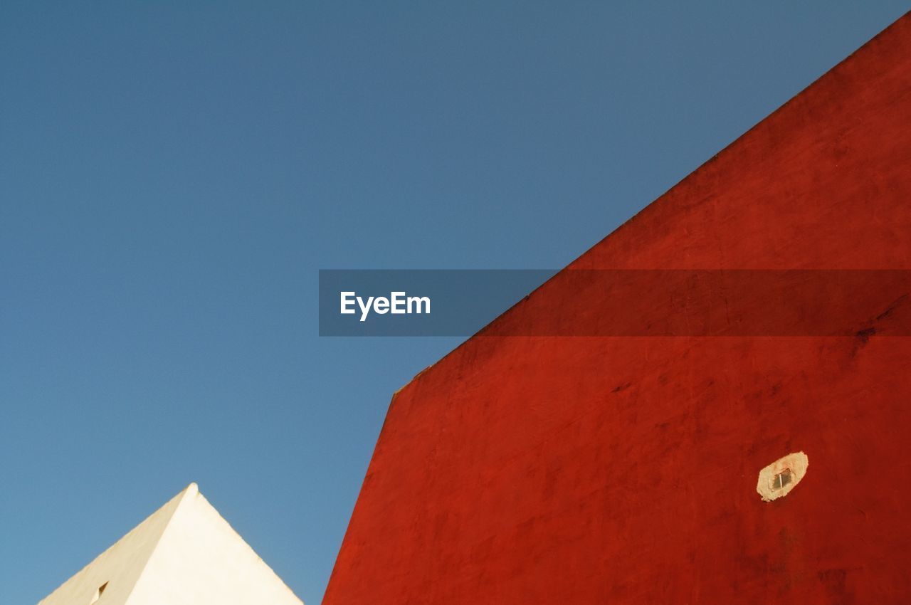 Low angle view of red building against clear sky