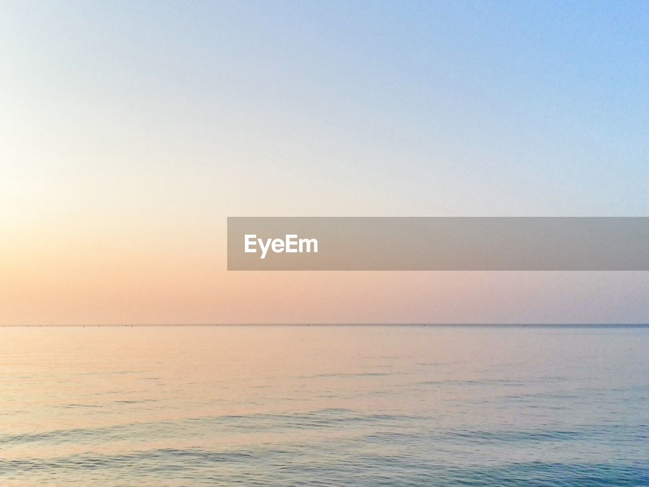 Scenic view of sea against clear sky during sunset 