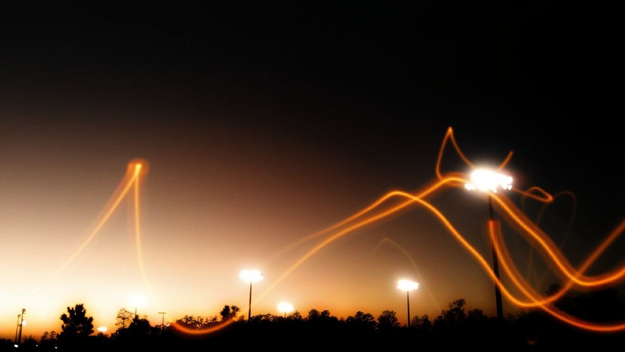 illuminated, night, sky, light, long exposure, motion, nature, silhouette, glowing, no people, copy space, lighting equipment, outdoors, light - natural phenomenon, celebration, sparkler, arts culture and entertainment, orange color