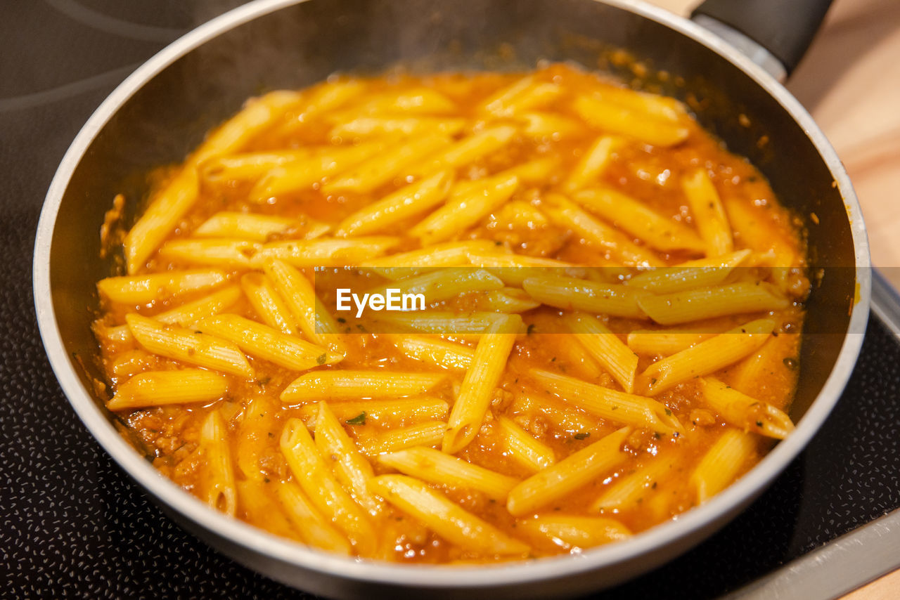 food, food and drink, fast food, dish, kitchen utensil, freshness, cuisine, healthy eating, indoors, penne, cooking pan, vegetable, household equipment, wellbeing, pasta, italian food, produce, bowl, no people, close-up, high angle view, studio shot, savory food, still life