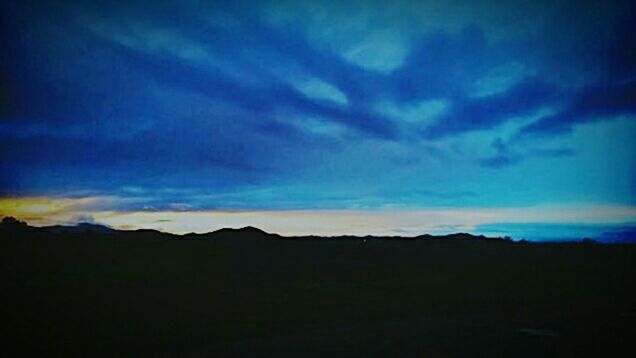 SILHOUETTE OF LANDSCAPE AGAINST SKY AT SUNSET