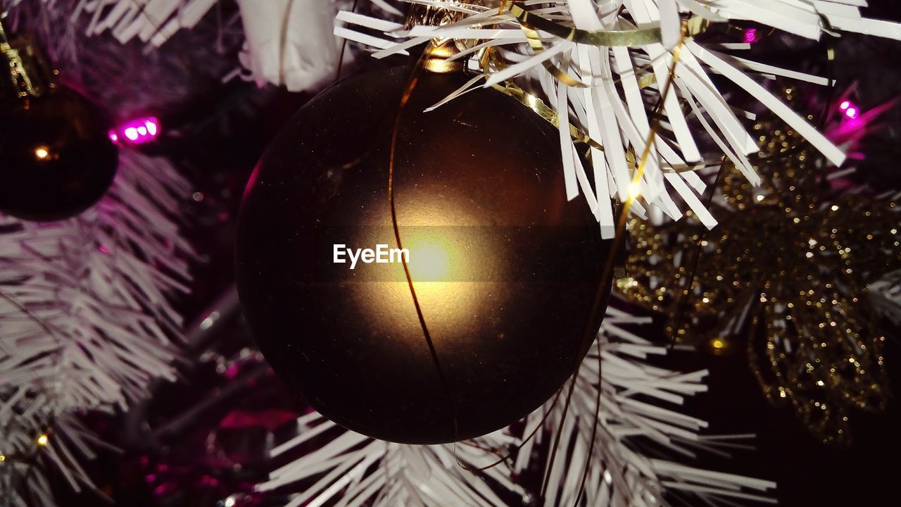 Close-up of golden ornament on christmas tree