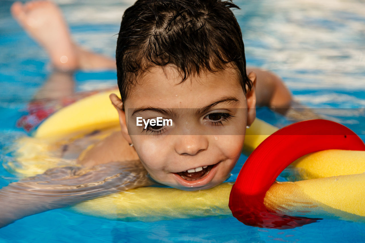 Smiling boy swimming in pool