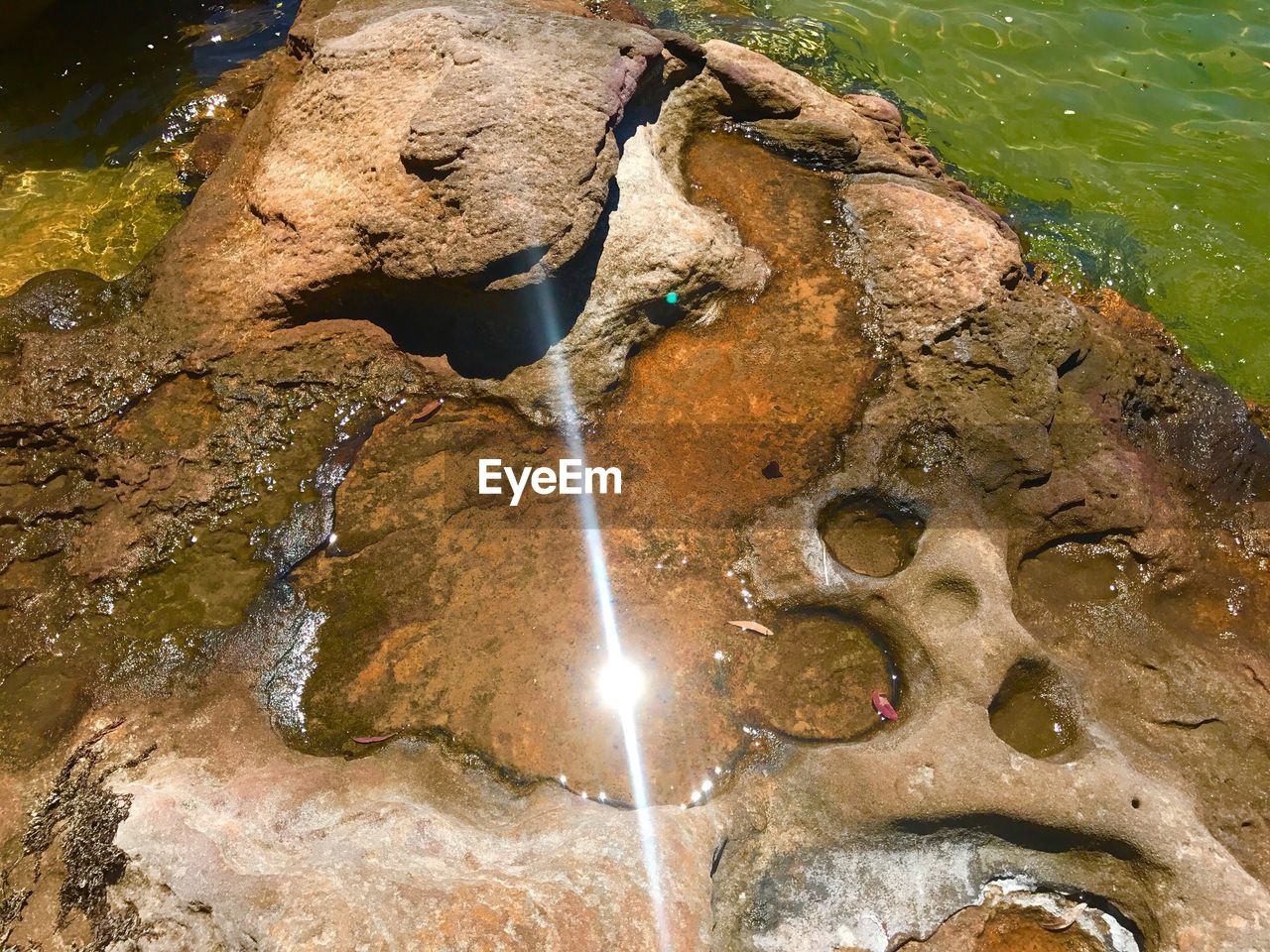 CLOSE-UP OF BUBBLES OVER WATER