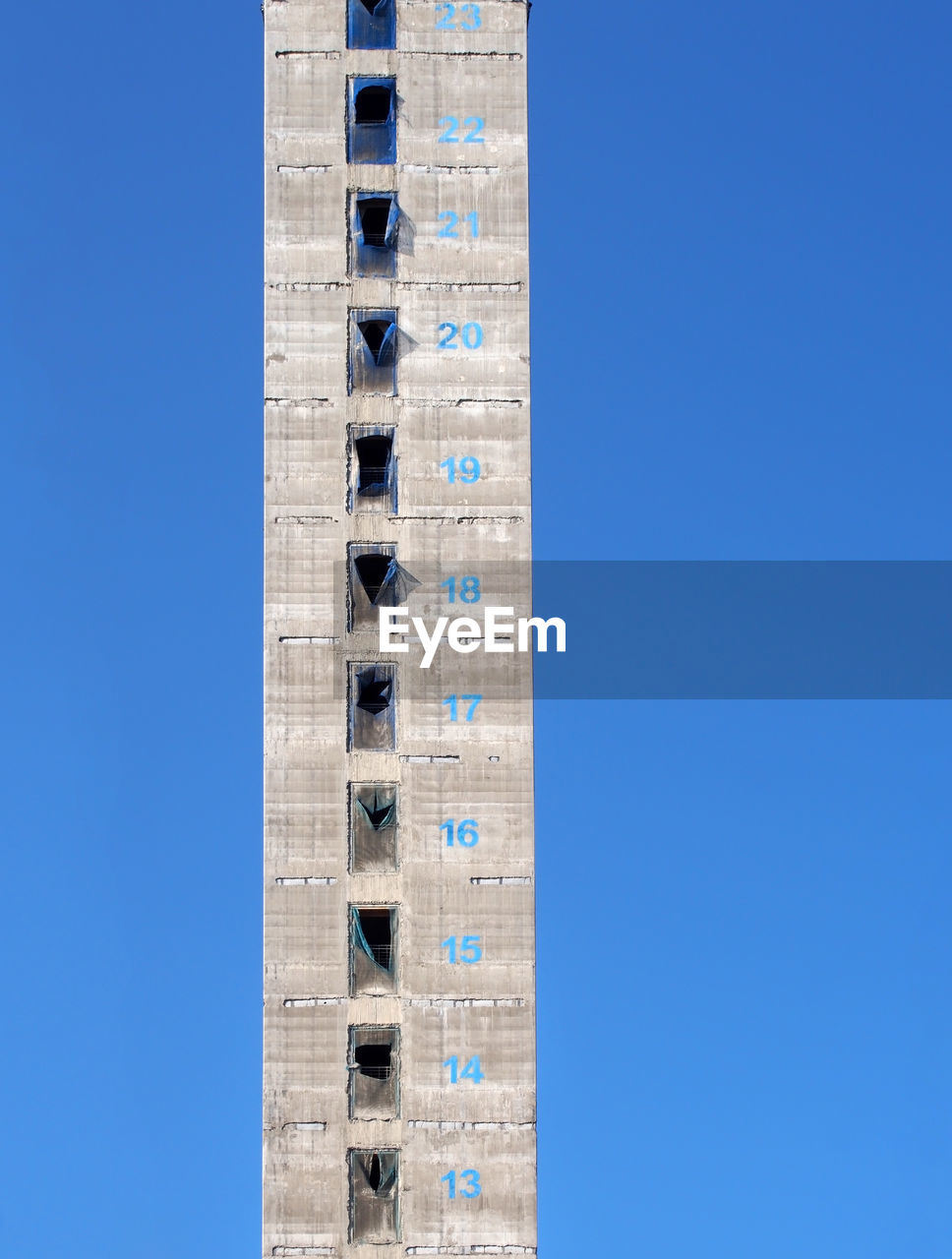 LOW ANGLE VIEW OF BUILDINGS AGAINST BLUE SKY