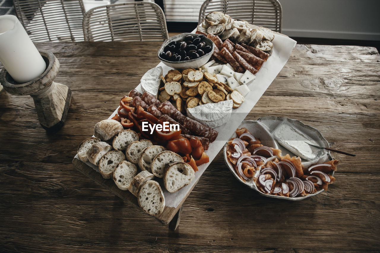 Party platter, grazing board with assortment of finger food on wooden table