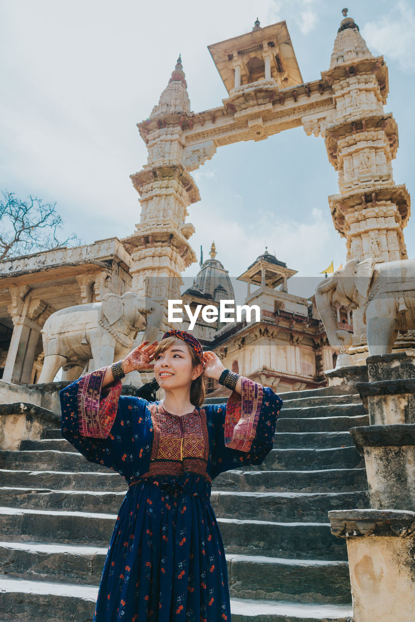 Woman standing outside temple