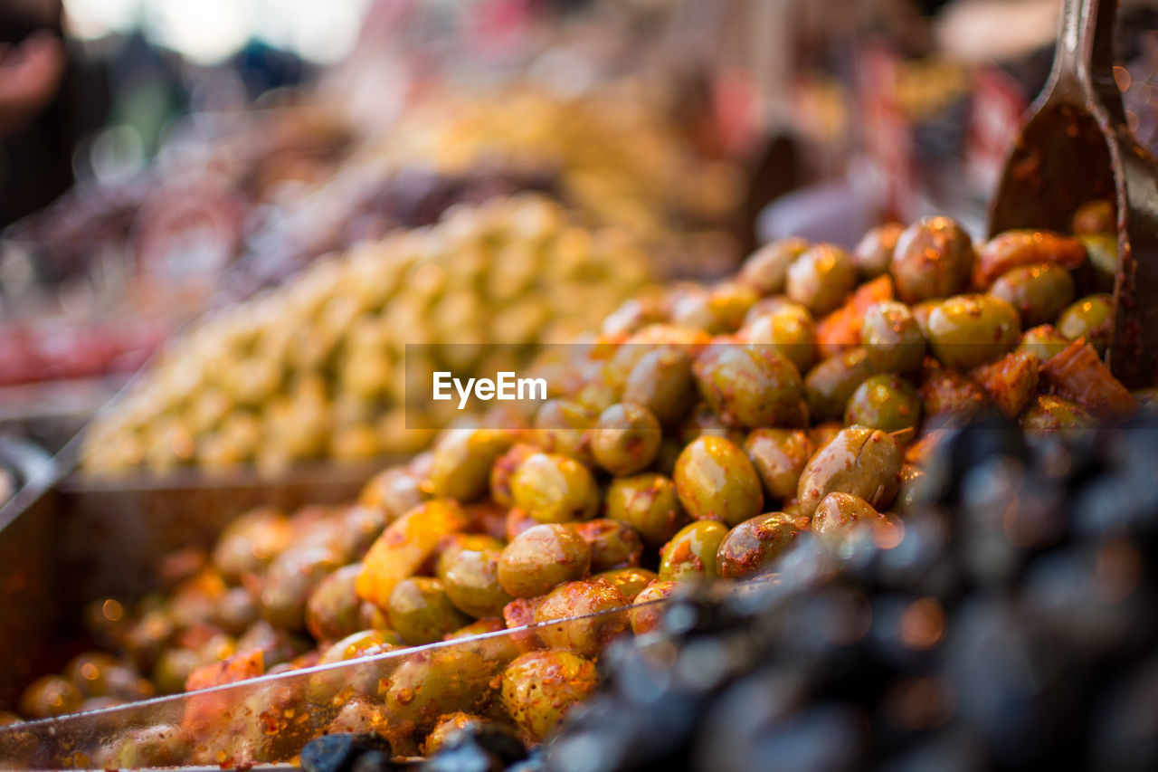 Close-up of spiced olives for sale at market stall