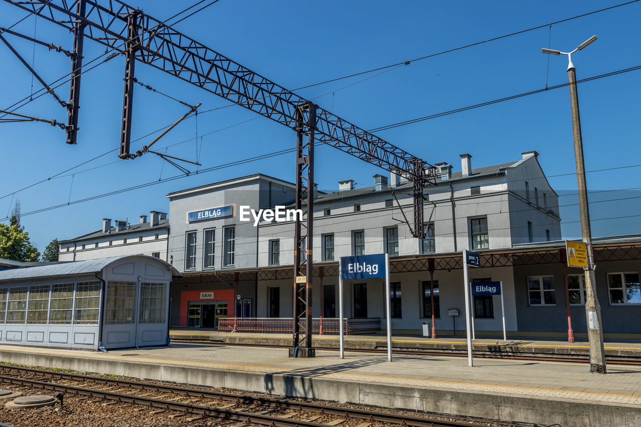 Railroad station platform against clear sky, train station in elblag, poland.