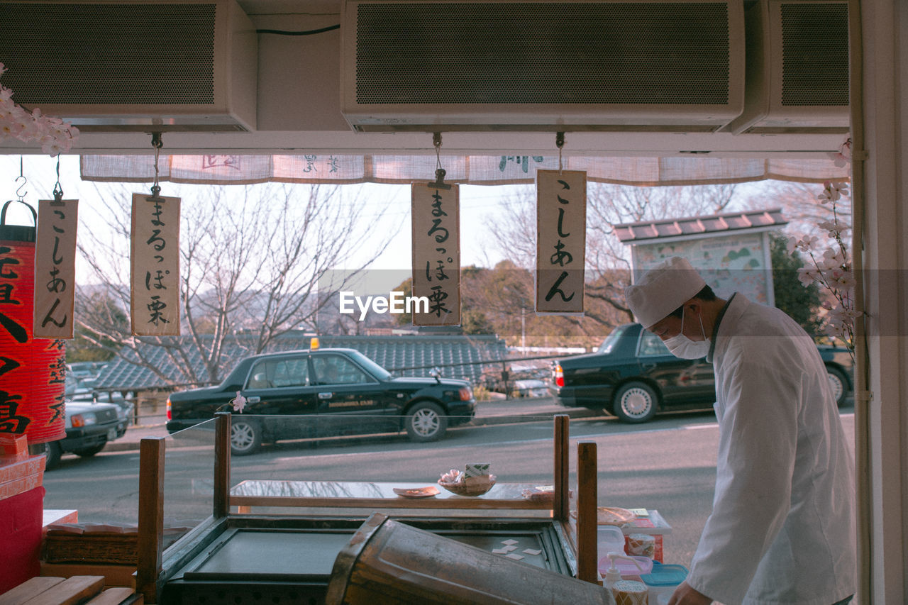 SIDE VIEW OF A MAN WORKING AT BUS