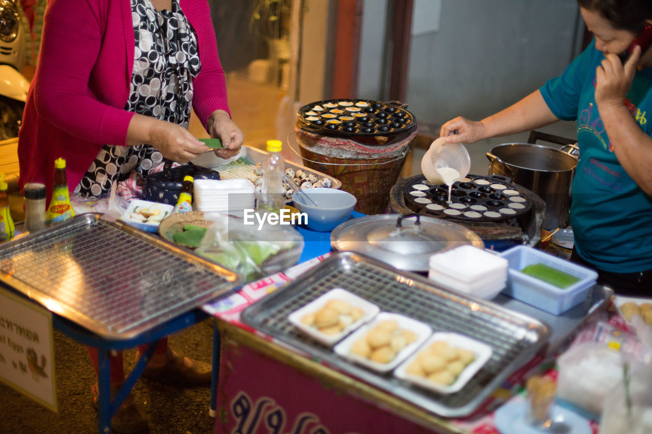 PEOPLE PREPARING FOOD ON TABLE