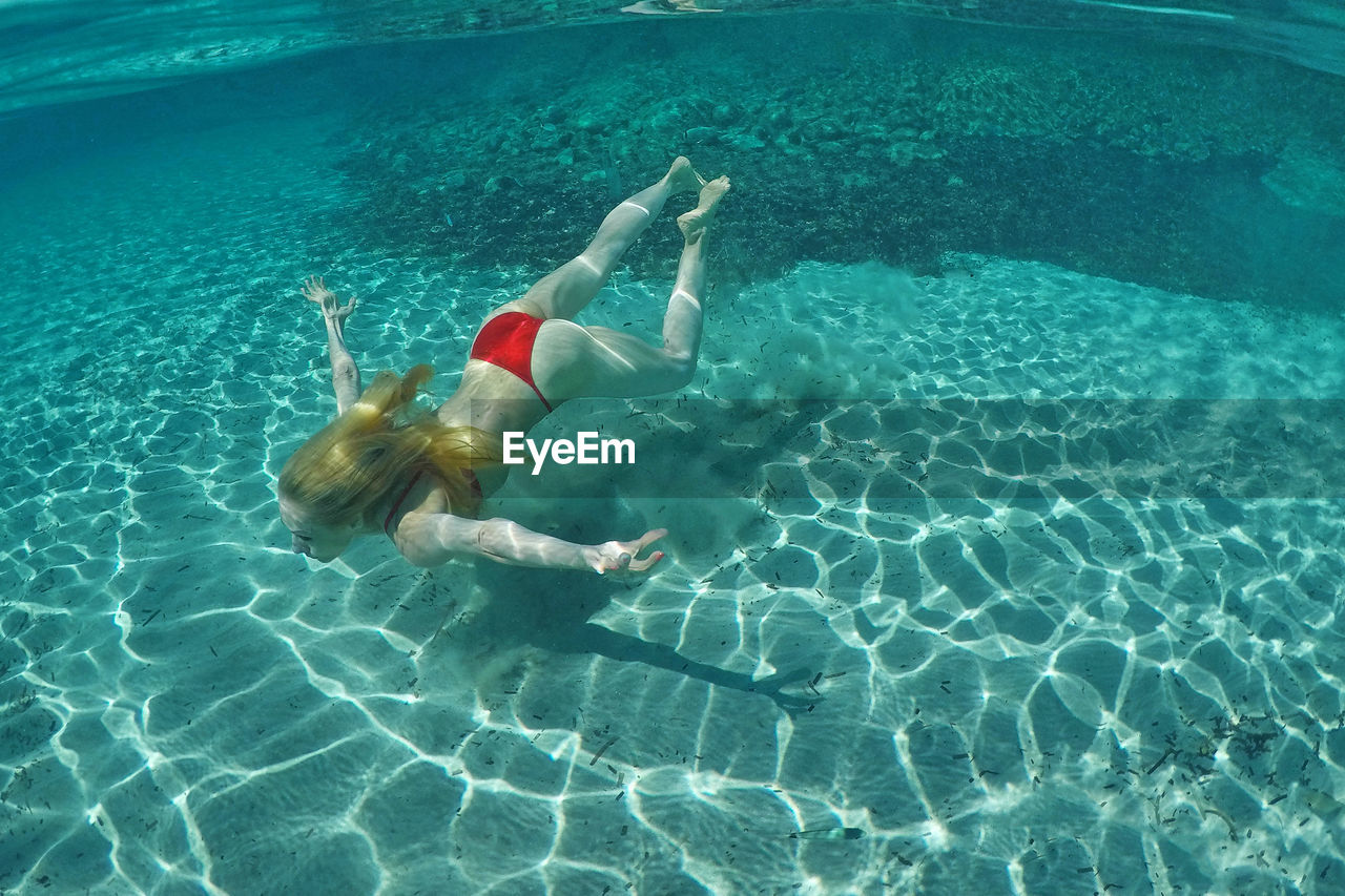 High angle view of woman swimming in sea