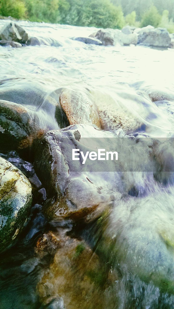 WAVES FLOWING THROUGH ROCKS