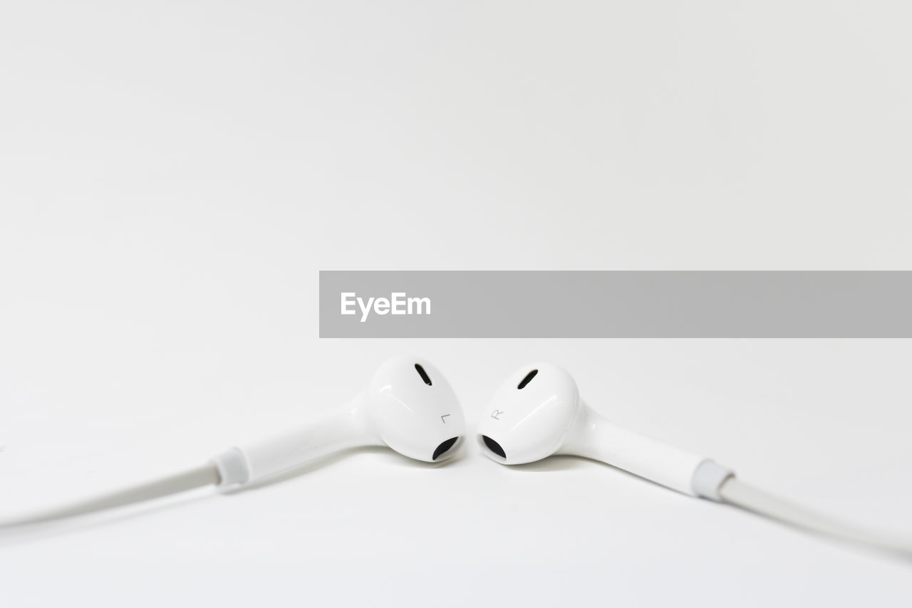 Close-up of in-ear headphones on white background