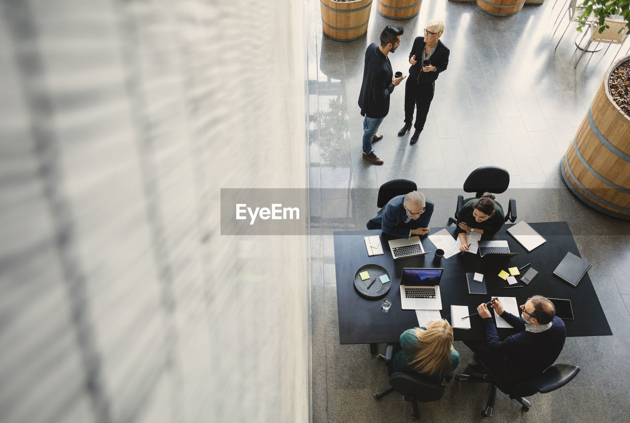 High angle view of business people working in creative office