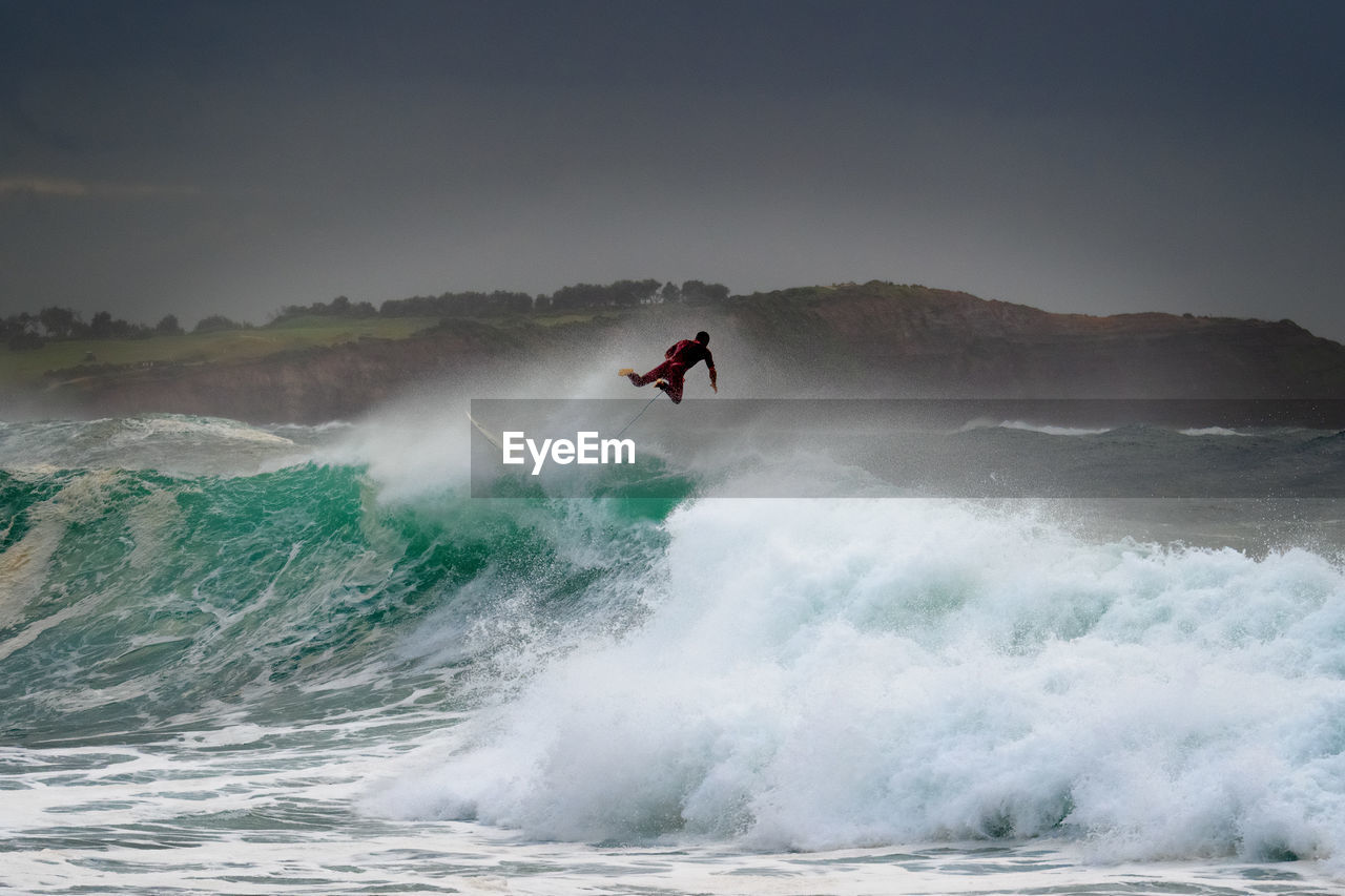 MAN SURFING IN SEA