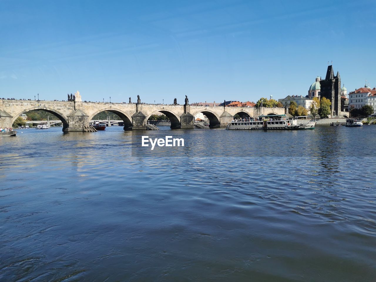 Bridge over river with buildings in background