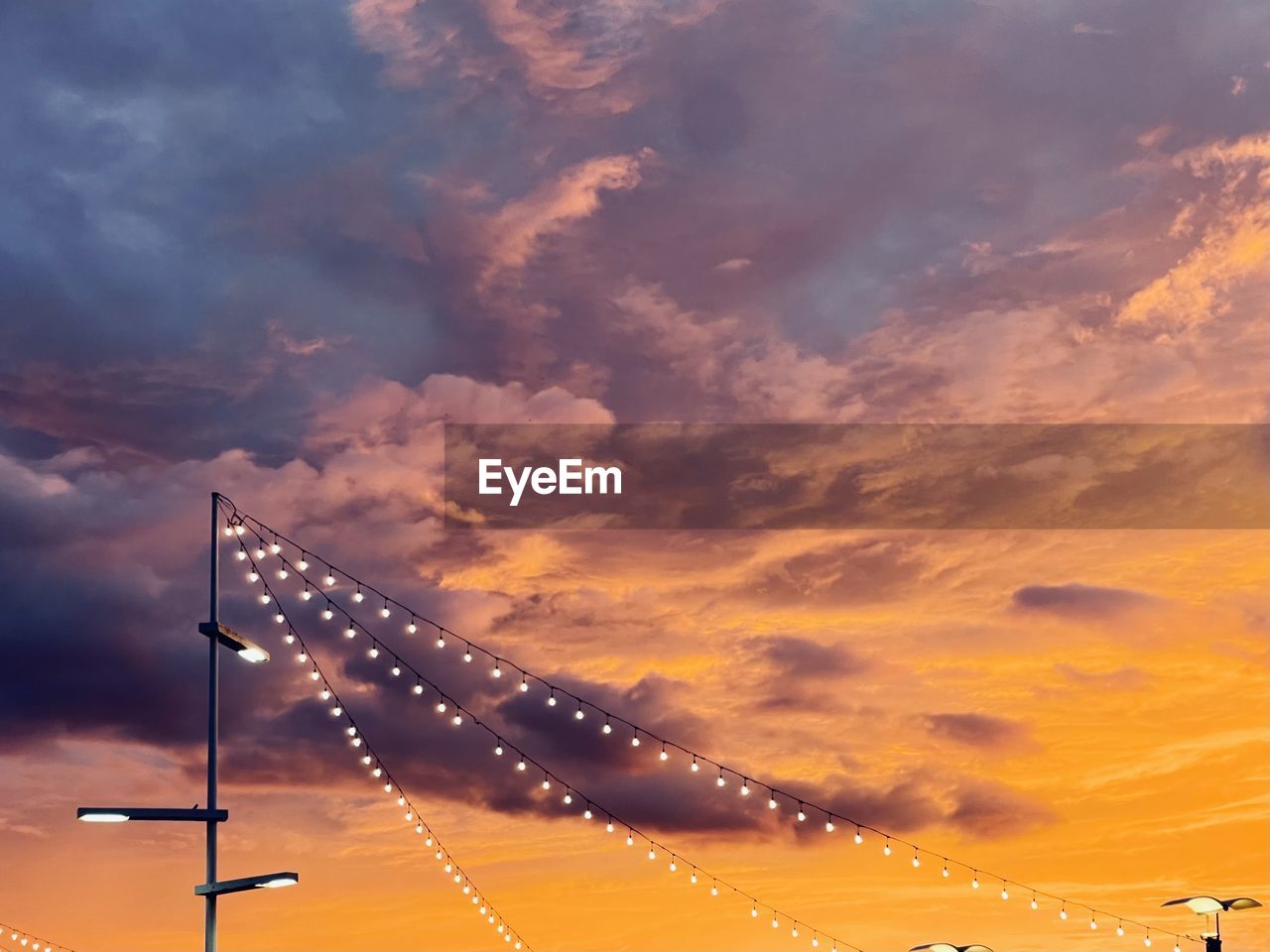 sky, cloud, horizon, sunset, sunlight, afterglow, dusk, nature, evening, orange color, no people, transportation, beauty in nature, lighting equipment, outdoors, architecture, dramatic sky, sun, street light, illuminated, street, scenics - nature