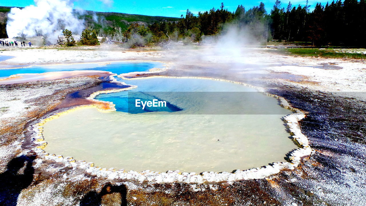 Scenic view of geyser from hot spring at yellowstone national park