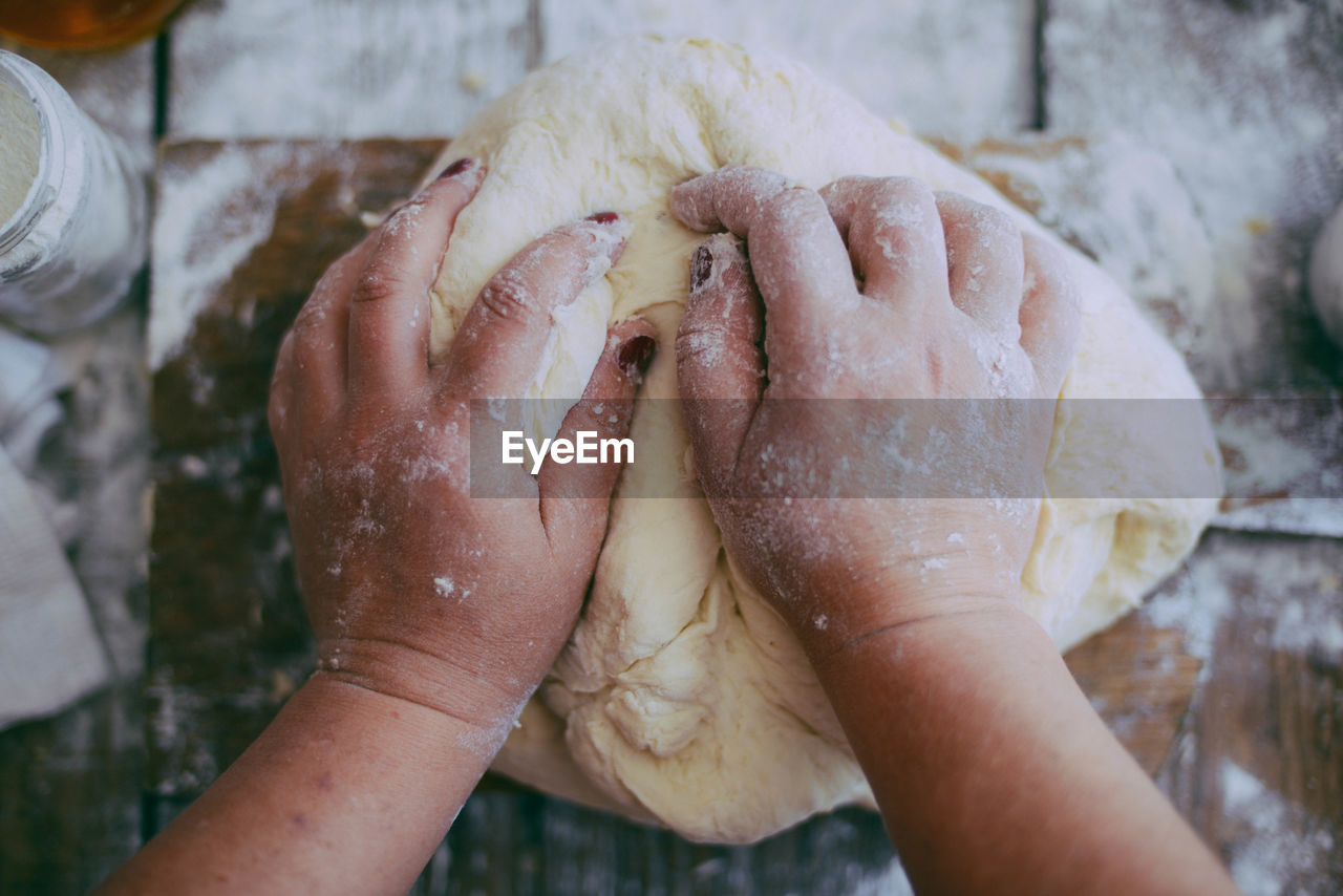 Close-up of hands kneading dough