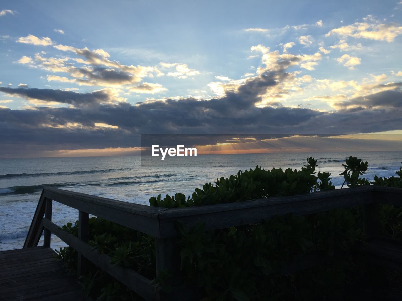 SCENIC VIEW OF BEACH AGAINST SKY DURING SUNSET