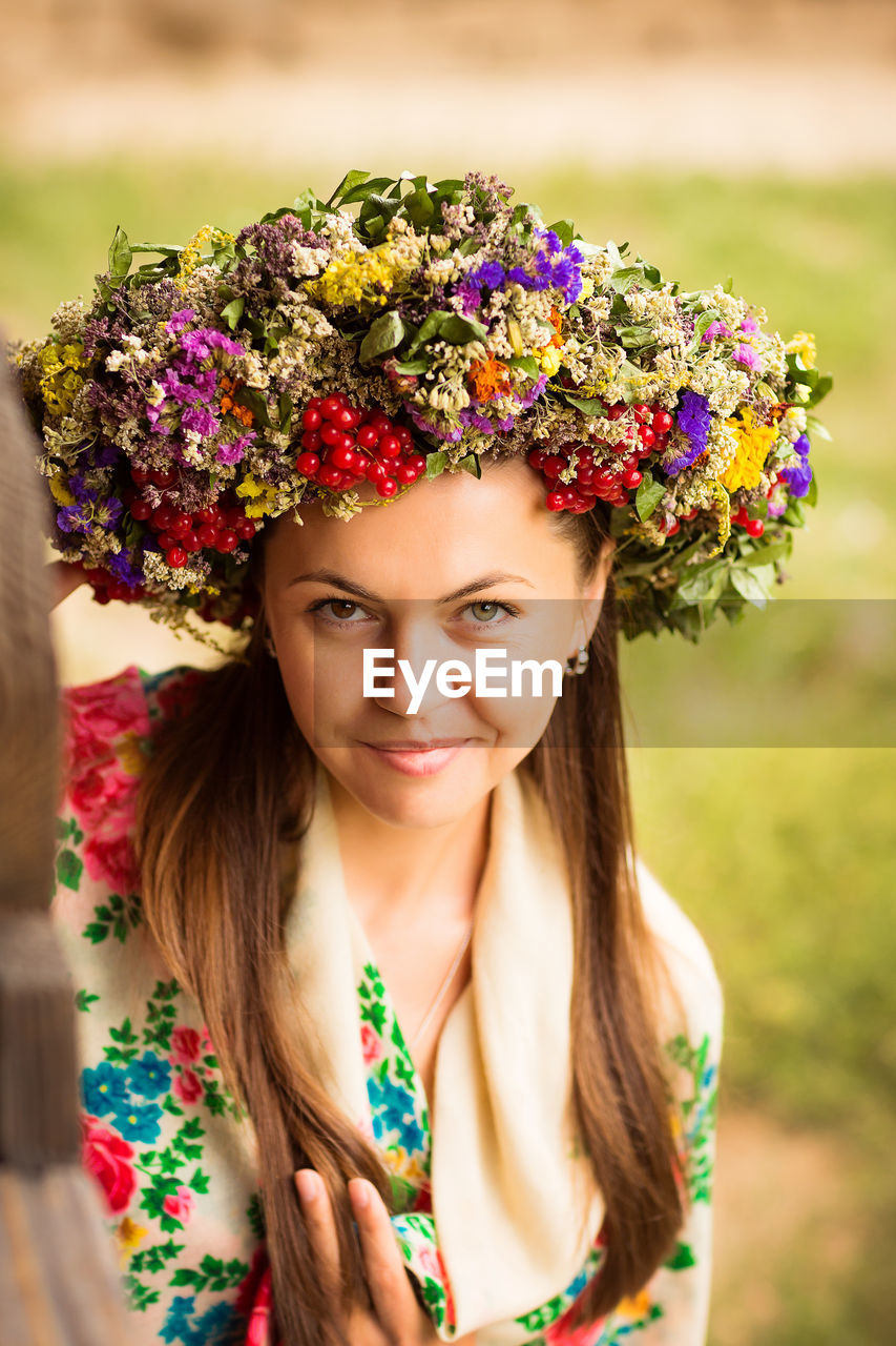 Young pretty ukrainian woman with a wreath of dry herbs on her head