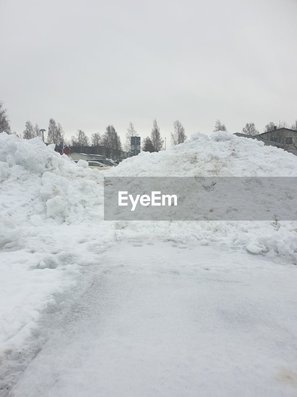 SNOW COVERED LAND AGAINST SKY DURING WINTER