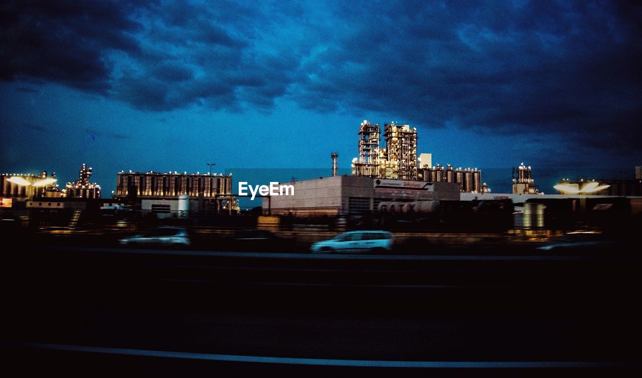 ILLUMINATED BUILDINGS IN CITY AT NIGHT