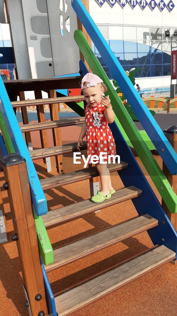 GIRL STANDING ON STAIRCASE